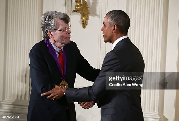President Barack Obama presents the 2014 National Medal of Arts to Stephen King during an East Room ceremony at the White House September 10, 2015 in...