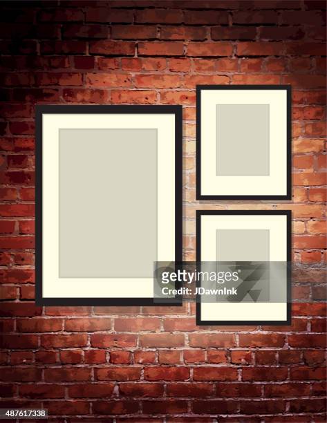 vertical brick wall background with three blank frames art gallery - wall hanging stock illustrations