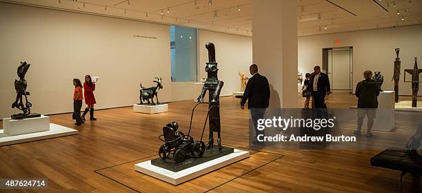 Viewers look at sculptures made by Pablo Picasso at the Museum of Modern Art's "Picasso Sculpture" exhibit on September 10, 2015 in New York City....