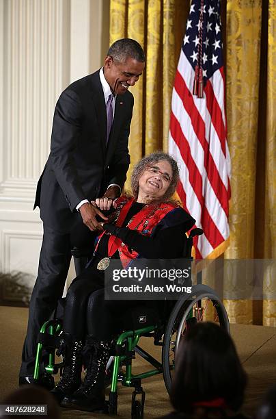 President Barack Obama presents the 2014 National Humanities Medal to Fedwa Malti-Douglas during an East Room ceremony at the White House September...