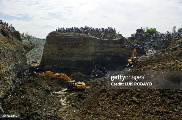 Rescuers work on the removal of sludge during the rescue of a group of miners in a gold mine that collapsed in San Antonio, rural area of Santander...