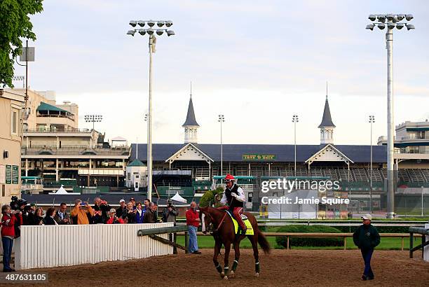 California Chrome walks off the track with trainer Art Sherman in front of the twin spires during early morning workouts at Churchill Downs on May 1,...