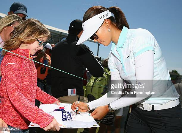 Michelle Wie signs autographs for fans after finishing Round One of the North Texas LPGA Shootout Presented by JTBC at the Las Colinas Country Club...