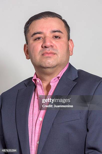 middle aged hispanic man in a blue suit - real businessman isolated no smile stock pictures, royalty-free photos & images