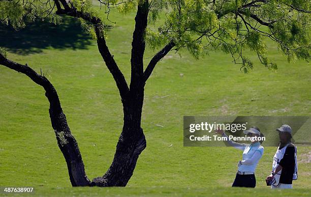 Michelle Wie talks with caddie Duncan French before hitting a shot during Round One of the North Texas LPGA Shootout Presented by JTBC at the Las...