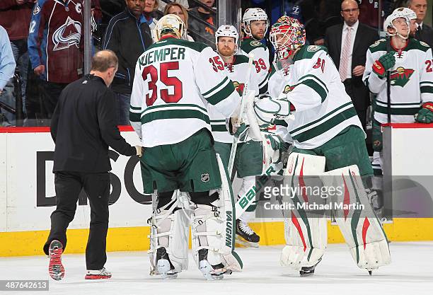 Goaltender Darcy Kuemper of the Minnesota Wild skates off the ice in the third period as he is replaced by goaltender Ilya Bryzgalov during Game...