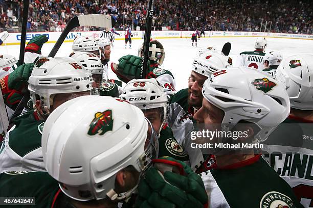 Kyle Brodziak of the Minnesota Wild celebrates a series win with teammates against the Colorado Avalanche after Game Seven of the First Round of the...