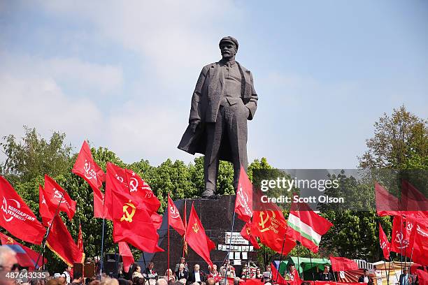 Communist party supporters march past a statue of Vladimir Lenin as they arrive for a May Day rally in Lenin Square on May 1, 2014 in Donetsk,...
