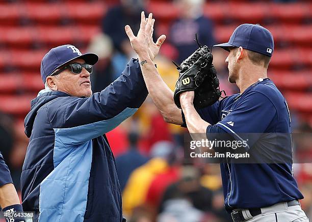 Joe Maddon of the Tampa Bay Rays celebrates with Grant Balfour, who earned a save in a 2-1 win over the Boston Red Sox in game one of a doubleheader...