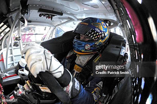 Chase Elliott, driver of the NAPA Auto Parts Chevrolet, sits in his car during practice for the NASCAR Nationwide Series Aaron's 312 at Talladega...