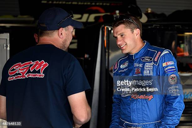 David Ragan, driver of the Carroll Shelby Engine Co Ford, stands in the garage area during practice for the NASCAR Nationwide Series Aaron's 312 at...