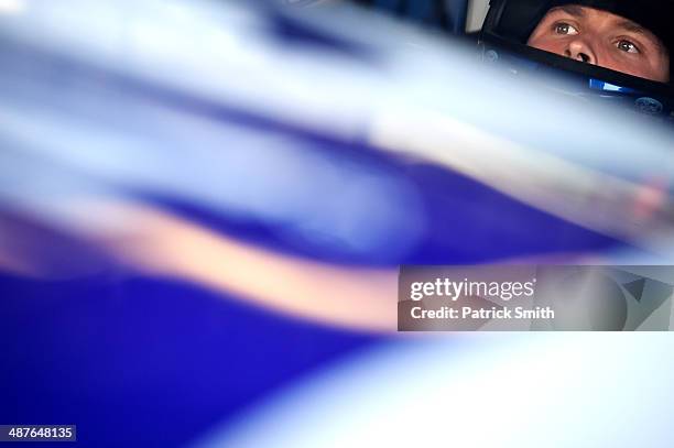 Trevor Bayne, driver of the AdvoCare Ford, sits in his car during practice for the NASCAR Nationwide Series Aaron's 312 at Talladega Superspeedway on...
