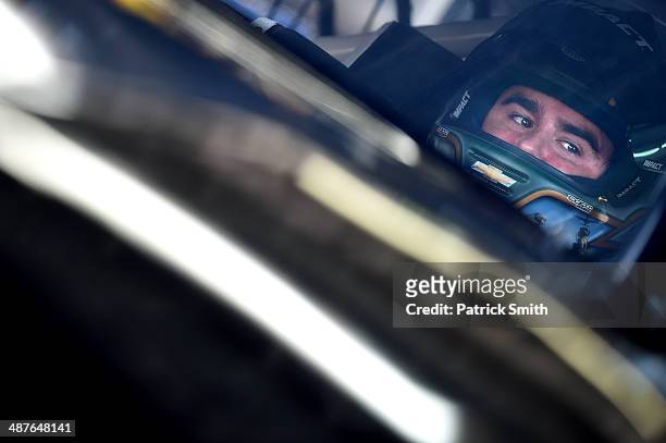 Brendan Gaughan, driver of the South Point Chevrolet, sits in his car during practice for the NASCAR Nationwide Series Aaron's 312 at Talladega...