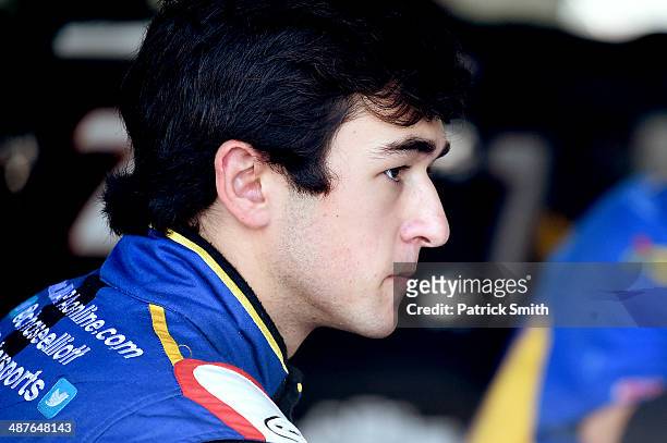 Chase Elliott, driver of the NAPA Auto Parts Chevrolet, stands in the garage area during practice for the NASCAR Nationwide Series Aaron's 312 at...