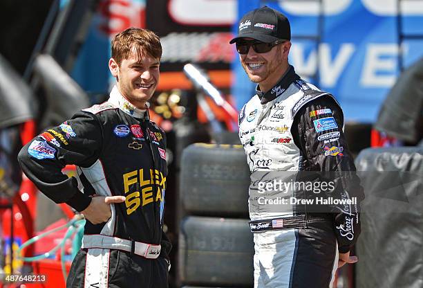 Landon Cassill, driver of the Flex Seal Chevrolet, talks with Brian Scott, driver of the Shore Lodge Chevrolet, during practice for the NASCAR...