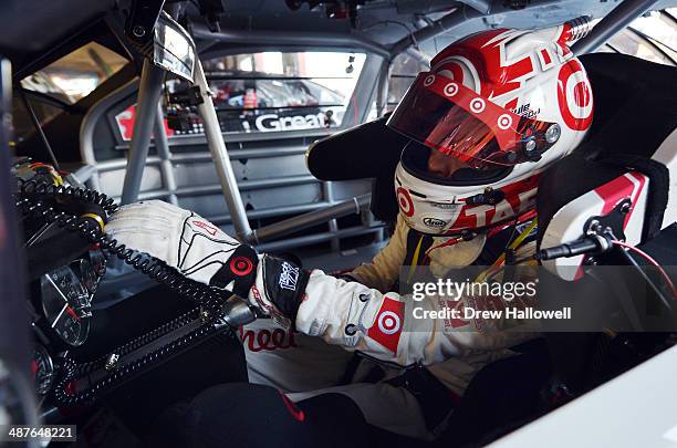 Kyle Larson, driver of the Cartwheel Chevrolet, sits in his car during practice for the NASCAR Nationwide Series Aaron's 312 at Talladega...