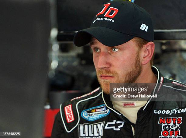 Jeffrey Earnhardt, driver of the FW1 Chevrolet, stands in the garage area during practice for the NASCAR Nationwide Series Aaron's 312 at Talladega...