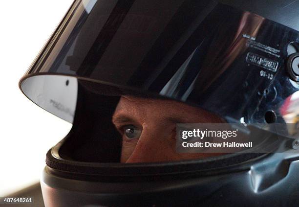 Josh Wise, driver of the Curtis Key Plumbing Chevrolet, sits in his car during practice for the NASCAR Nationwide Series Aaron's 312 at Talladega...