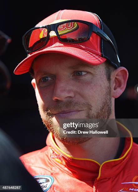 Regan Smith, driver of the Ragu Chevrolet, stands in the garage area during practice for the NASCAR Nationwide Series Aaron's 312 at Talladega...