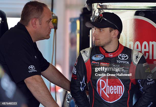 James Buescher, driver of the Rheem Toyota, stands in the garage area during practice for the NASCAR Nationwide Series Aaron's 312 at Talladega...