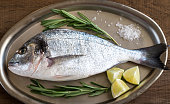 Fresh dorada with ingredients on the vintage tray