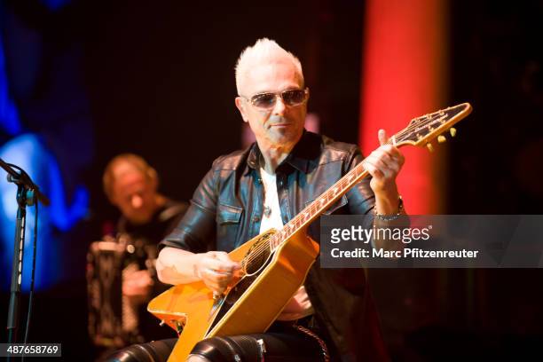 Lead guitarist Rudolf Schenker of German heavy metal band Scorpions performs during their 'MTV Unplugged Tour' at the Lanxess Arena on May 01, 2014...