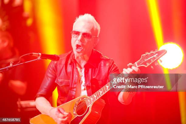 Lead guitarist Rudolf Schenker of German heavy metal band Scorpions performs during their 'MTV Unplugged Tour' at the Lanxess Arena on May 01, 2014...