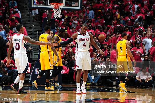 Jeff Teague and Paul Millsap of the Atlanta Hawks high five during Game Six of the Eastern Conference Quarterfinals against the Indiana Pacers on May...