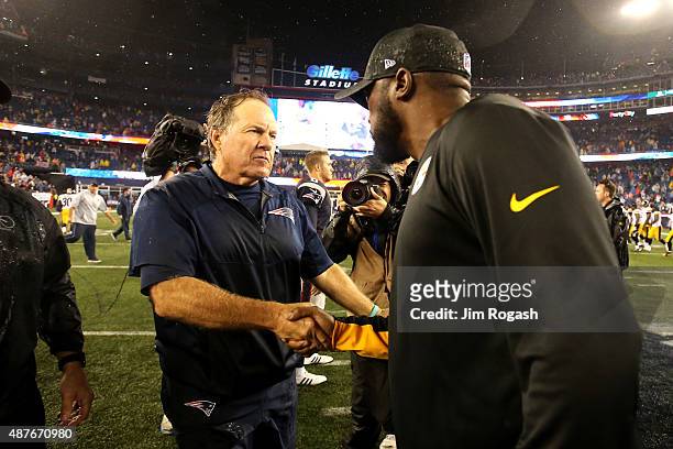 Head coach Bill Belichick of the New England Patriots and head coach Mike Tomlin of the Pittsburgh Steelers shake hands after the Patriots defeated...