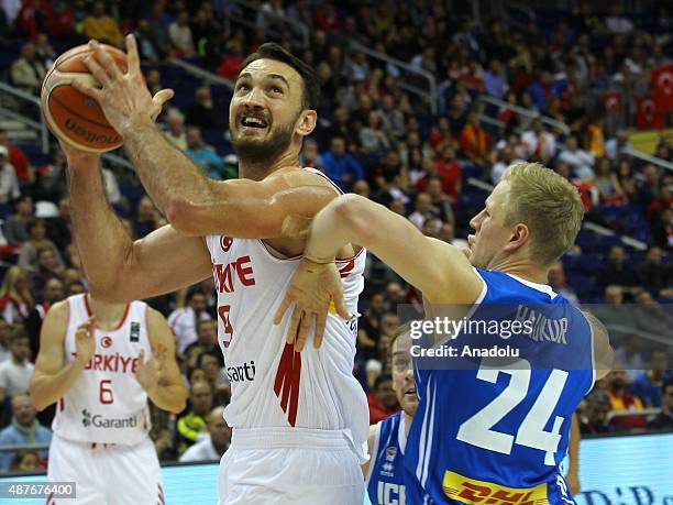 Semih Erden of Turkey vies for the ball during the FIBA EuroBasket 2015 Group B basketball match between Turkey vs Iceland at Mercedes Benz Arena in...