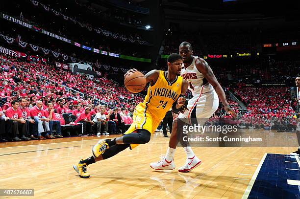 Paul George of the Indiana Pacers drives to the basket during Game Six of the Eastern Conference Quarterfinals against Paul Millsap of the Atlanta...