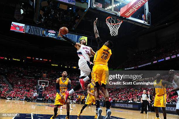 Mike Scott of the Atlanta Hawks drives to the basket during Game Six of the Eastern Conference Quarterfinals against Ian Mahinmi of the Indiana...