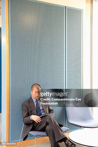 businessman using digital tablet in modern office - businesswear stock pictures, royalty-free photos & images