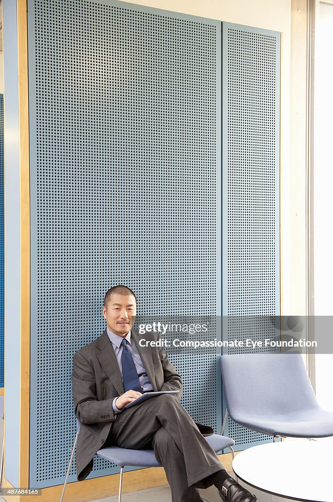 Businessman using digital tablet in modern office