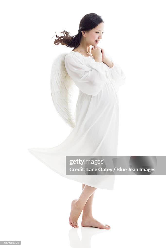 Pregnant woman wearing angel wings