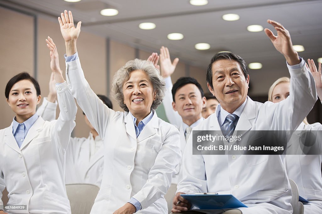 Medical workers raising hands