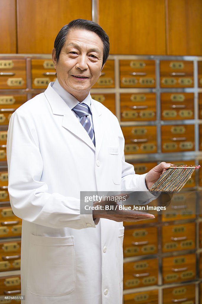 Senior doctor with dry centipedes