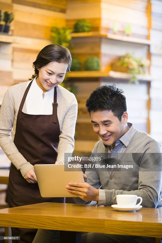 Customers Using Tablets Customer Using Digital Tablet For Ordering High-Res Stock Photo - Getty ...