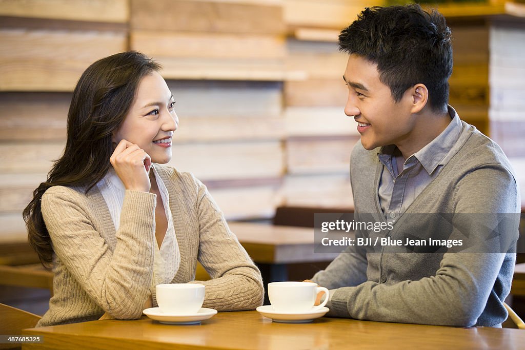 Young couple chatting in cafe