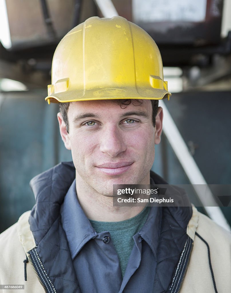 Caucasian construction worker smiling outdoors