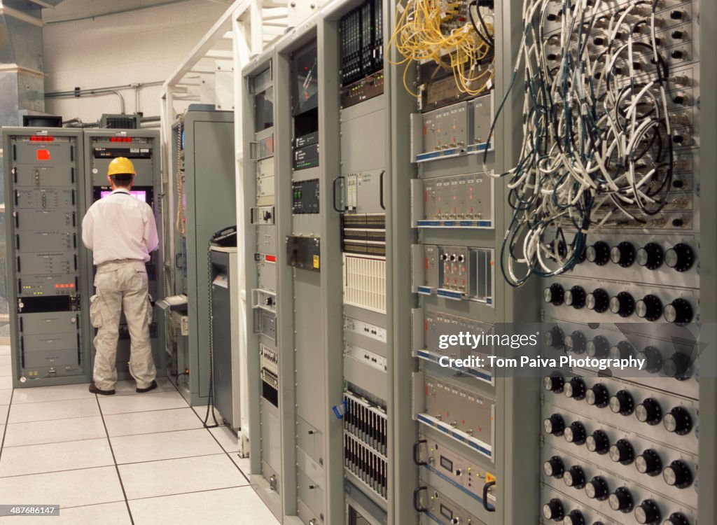 Computer programmer working in server room