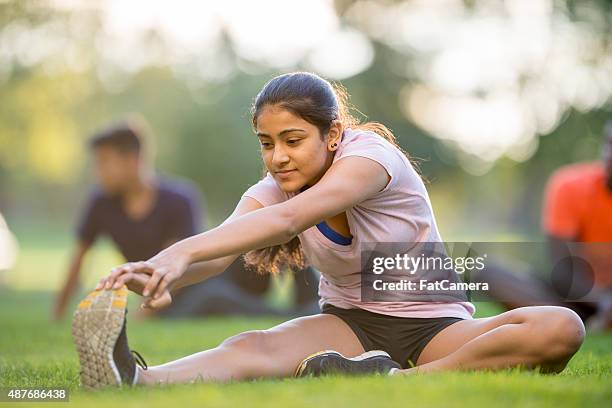 exersizing and stretching in the park - teens exercising stock pictures, royalty-free photos & images