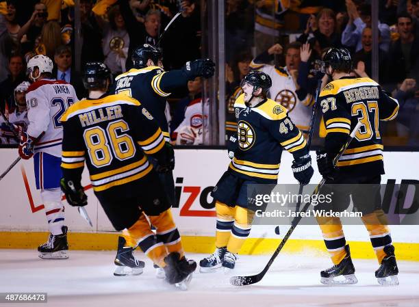 Torey Krug of the Boston Bruins celebrates his goal with teammates in the third period against the Montreal Canadiens in Game One of the Second Round...