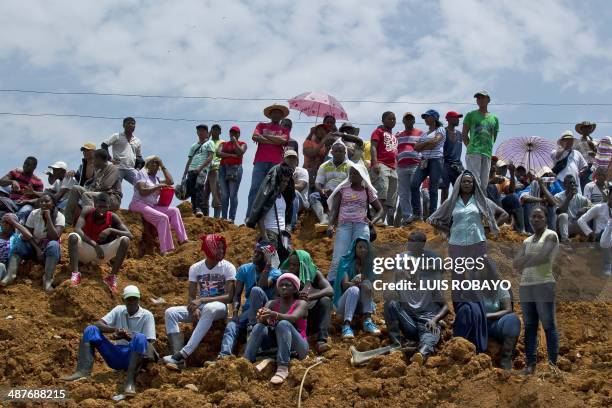 Miners look at the rescue operations after a gold mine collapsed in San Antonio, rural area of Santander de Quilichao, department of Cauca, Colombia,...
