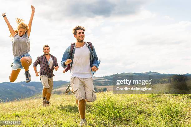 group of friends running free - friends hiking stock pictures, royalty-free photos & images