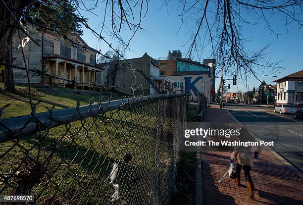 Pedestrian passes decaying homes in the 2200 block of Martin Luther King Avenue in Washington, DC on January 17, 2014. The parcel, better known as...