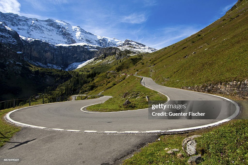 Hairpin curve, mountain road to the Klausen Pass in front of the Glarus Alps, Urnerboden, Canton of Uri, Switzerland