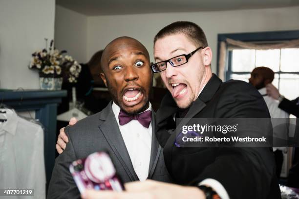 groom and groomsman taking silly self-portrait - trauzeuge des bräutigams stock-fotos und bilder