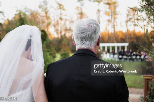 caucasian father walking bride down aisle - bride walking stock pictures, royalty-free photos & images