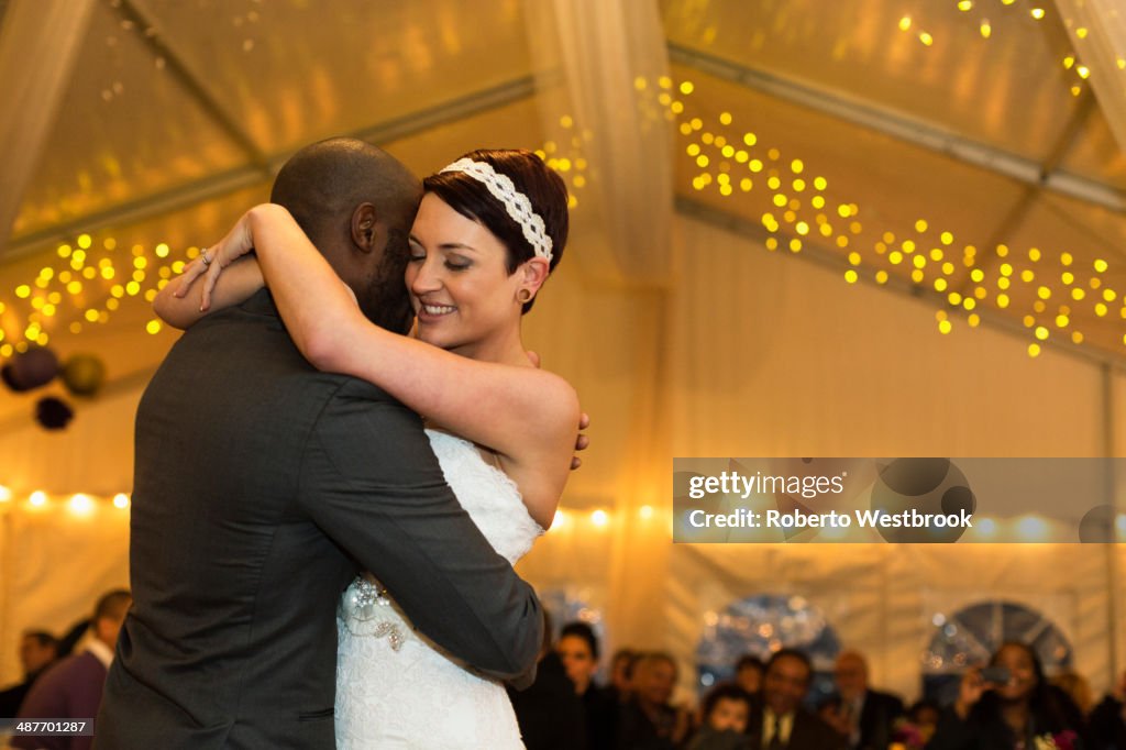 Newlywed couple dancing at reception